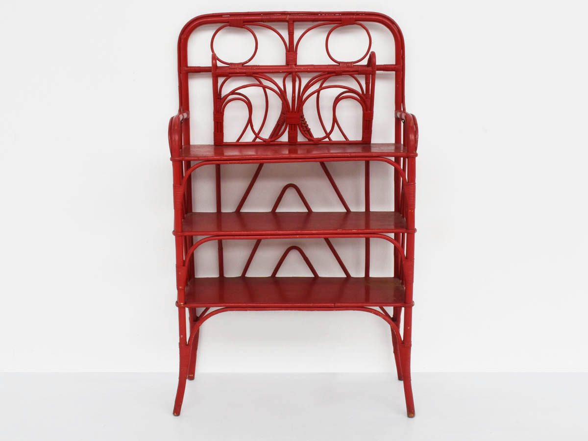 Red painted rattan bookcase with butterfly magazine holder